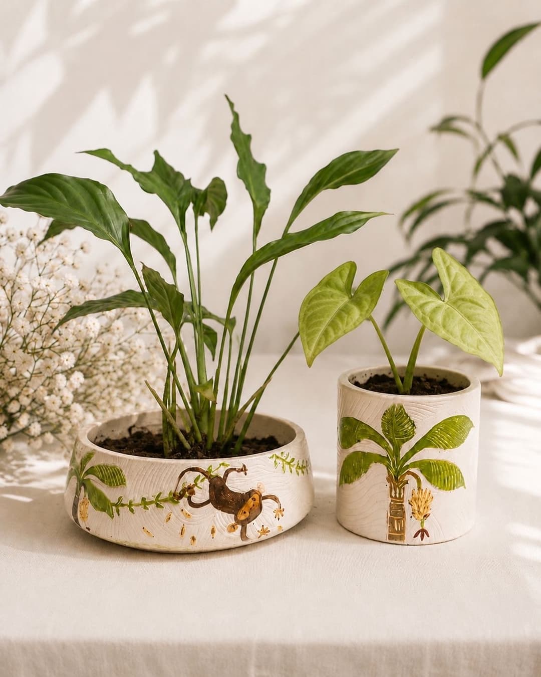 Ru's Jungle Story handcrafted planter pair on wooden studio bench